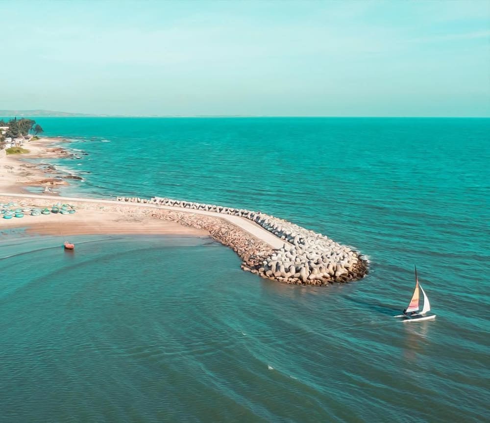 Ong Dia Beach displaying unique rock formations creating natural pools along the golden sand coastline